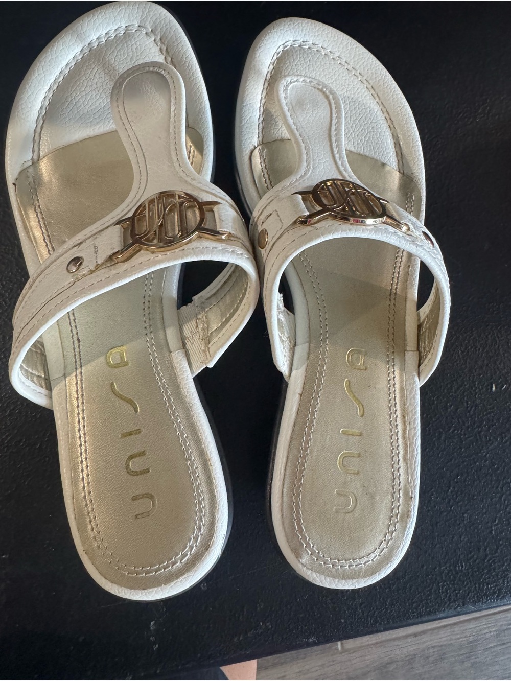 Unisa White Leather Toe-Post Sandals with Gold Emblem